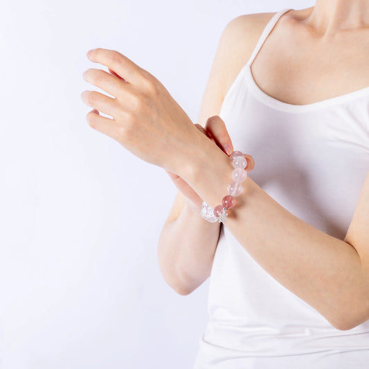 Pink Rose Quartz Crystal bracelet worn on wrist, feminine and stylish.