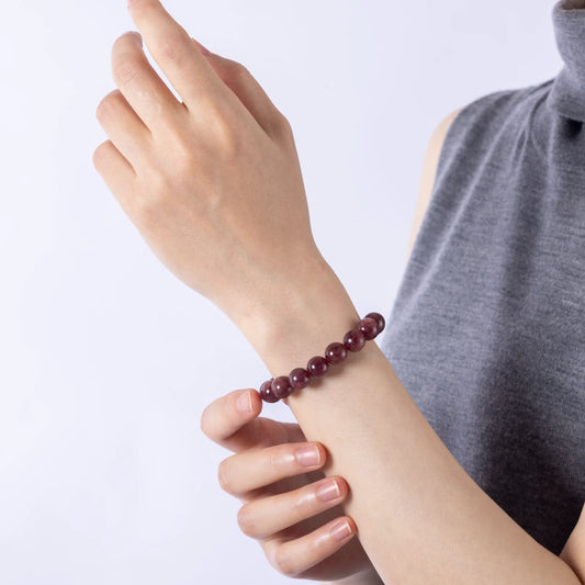 Wrist wearing Dare to Mystic Strawberry Quartz Bracelet, serene energy.