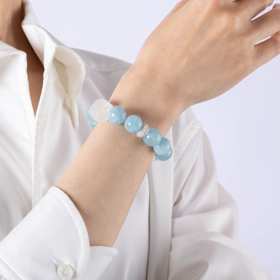Model showing aquamarine gem bracelet on hand