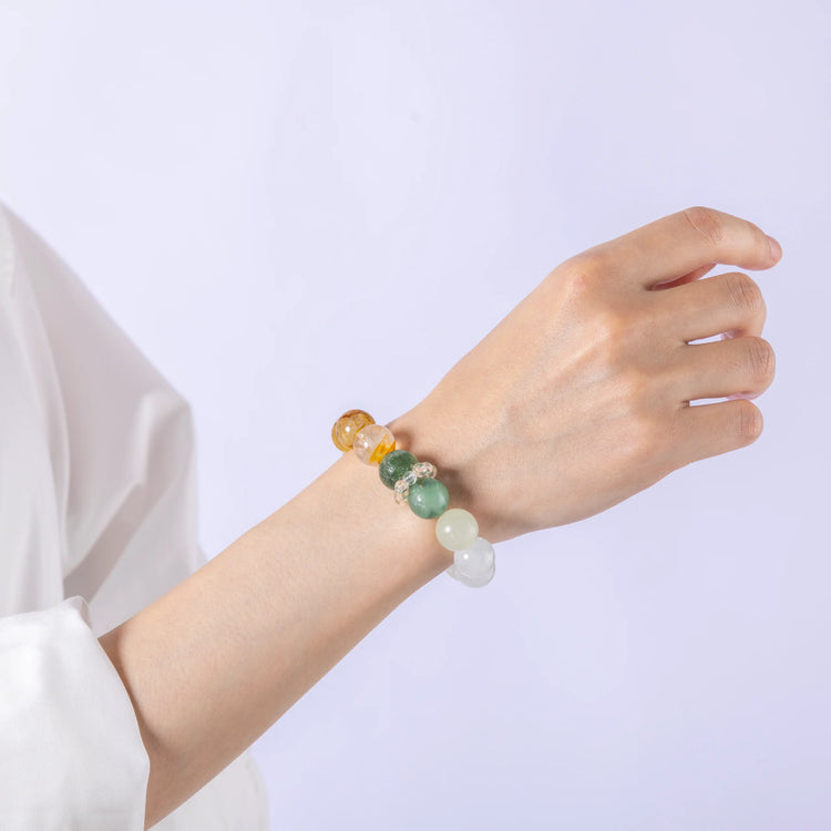 Forest Tempo Garden Quartz & Green Strawberry Quartz Bracelet laid flat in a circular arrangement, showing all seven gemstone colors.