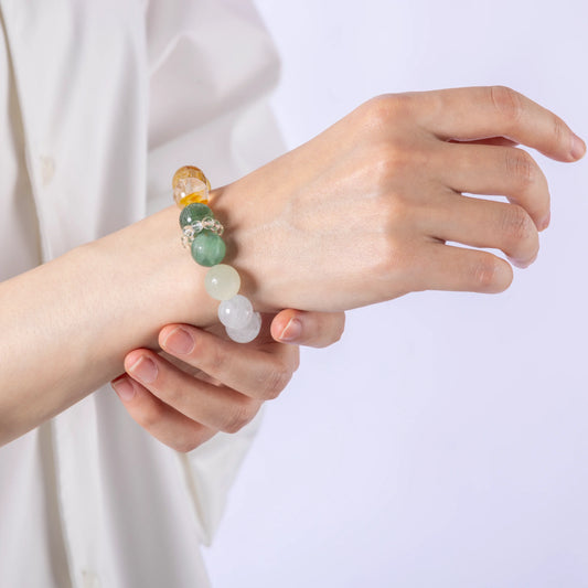 Forest Tempo Garden Quartz & Green Strawberry Quartz Bracelet laid flat in a circular arrangement, showing all seven gemstone colors.