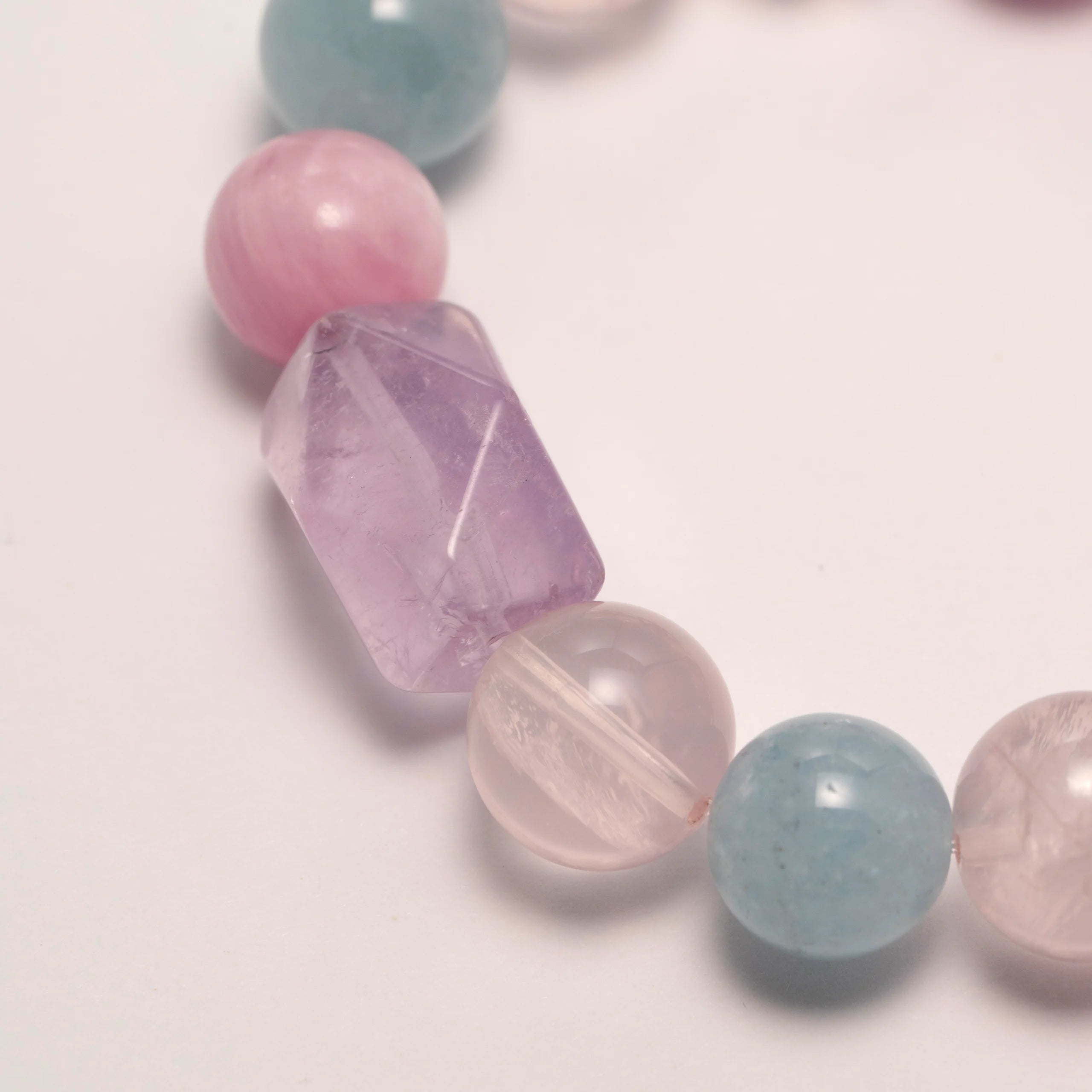 Lepidolite Crystal & Purple Rutilated Quartz Bracelet featuring Lepidolite, Aquamarine, Purple Rutilated Quartz, and faceted Lavender Amethyst for emotional clarity and inner peace