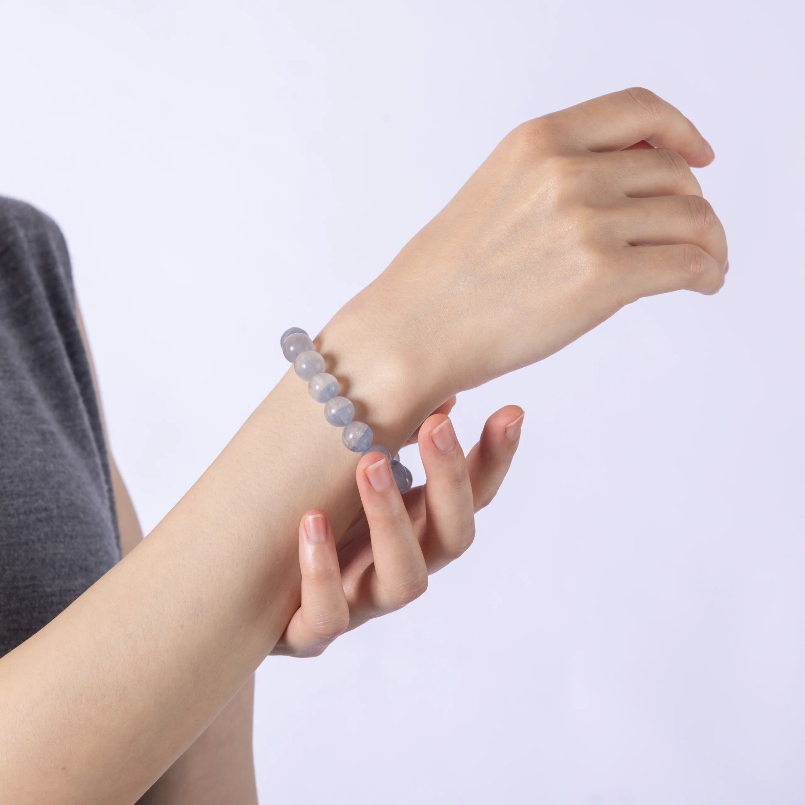 Wrist wearing Dare to Mystic Fluorite Stone bracelet, calming energy.