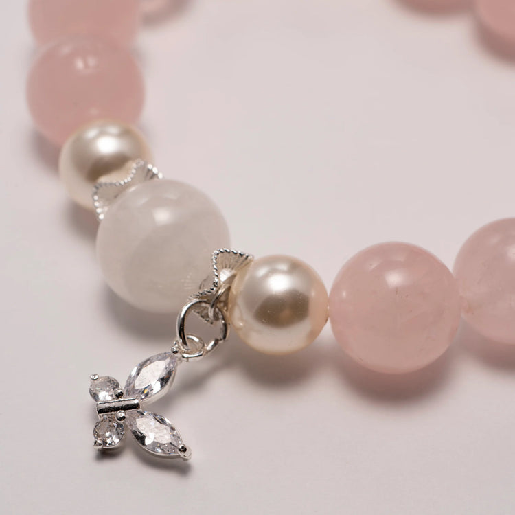 rose quartz bead bracelet glowing under natural light.