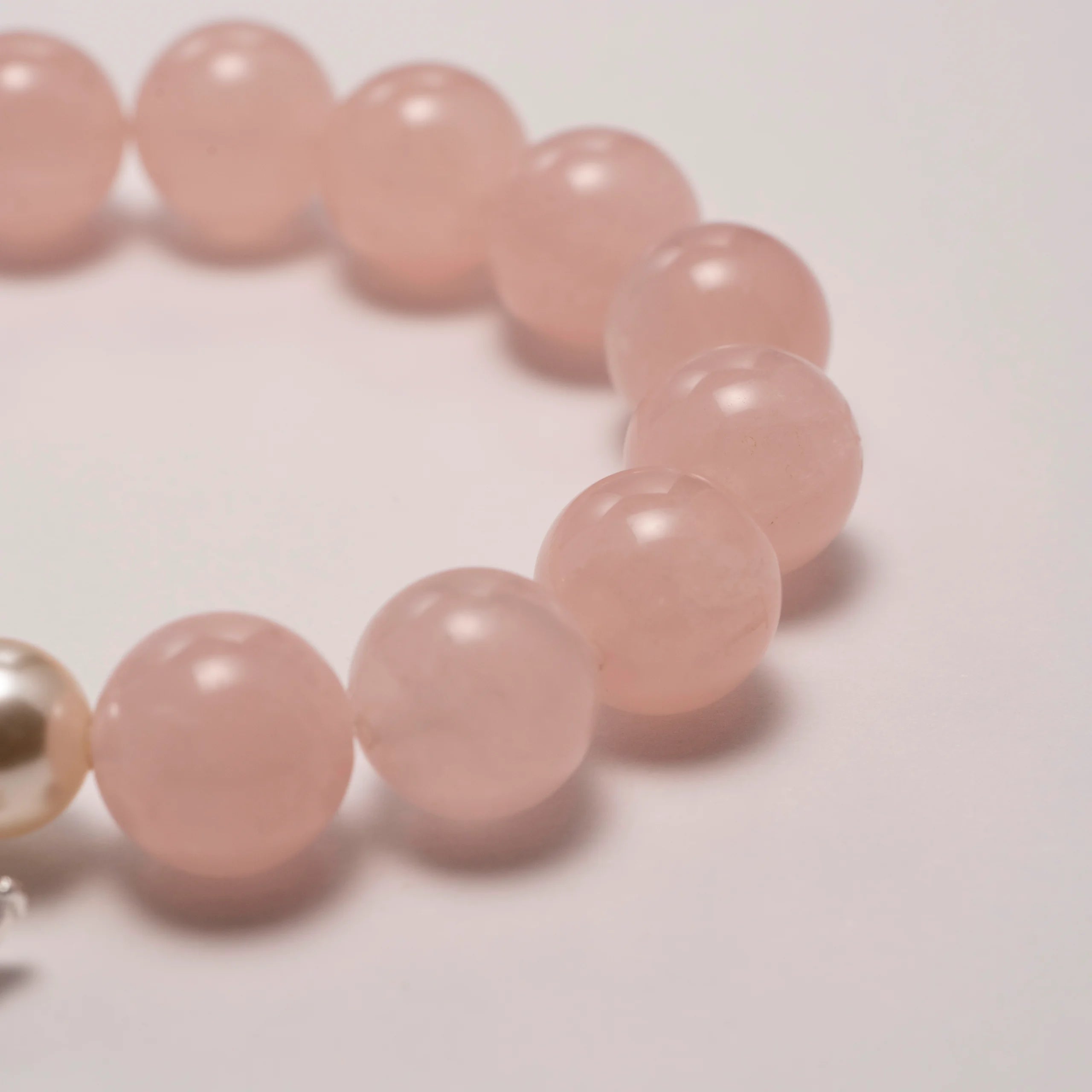 rose quartz bead bracelet close-up detail view.