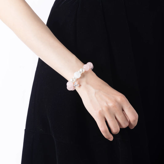 model wearing rose quartz bead bracelet lifestyle shot.